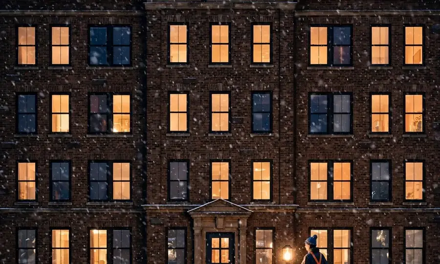 Brick apartment building in the Bronx at night during falling snow