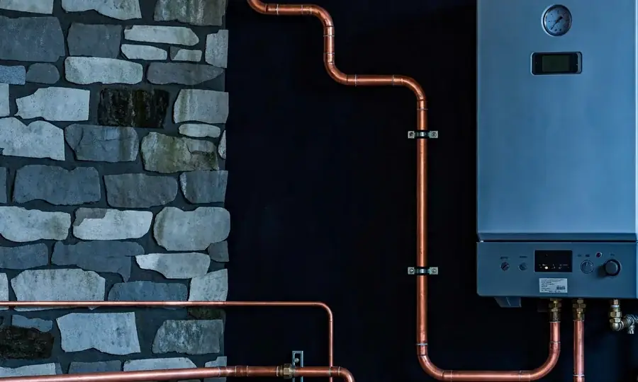 newly installed wall-mounted boiler with copper pipework